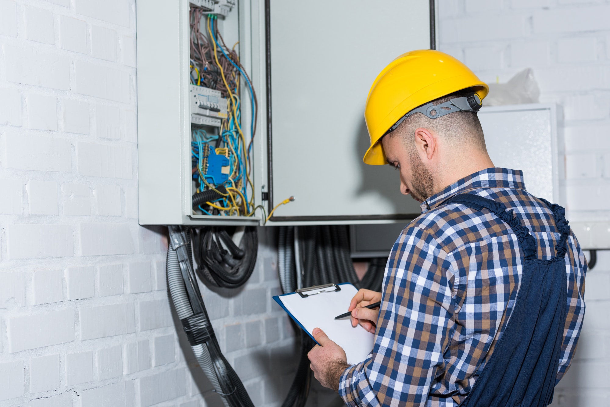 Inicio 8 professional electrician inspecting wires in electrical